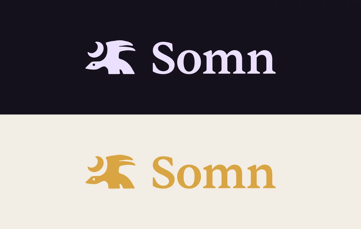 Somn logotype displayed in lavender on dark background and amber gold on cream background
